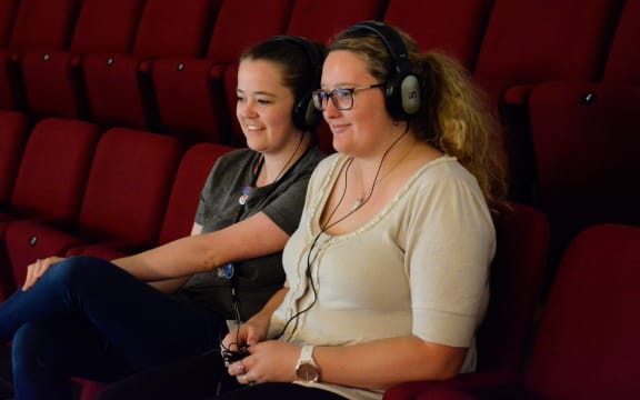 The APO's Katie Deller and Rowan Newton test out the new device to help those with hearing sensitivity at concerts