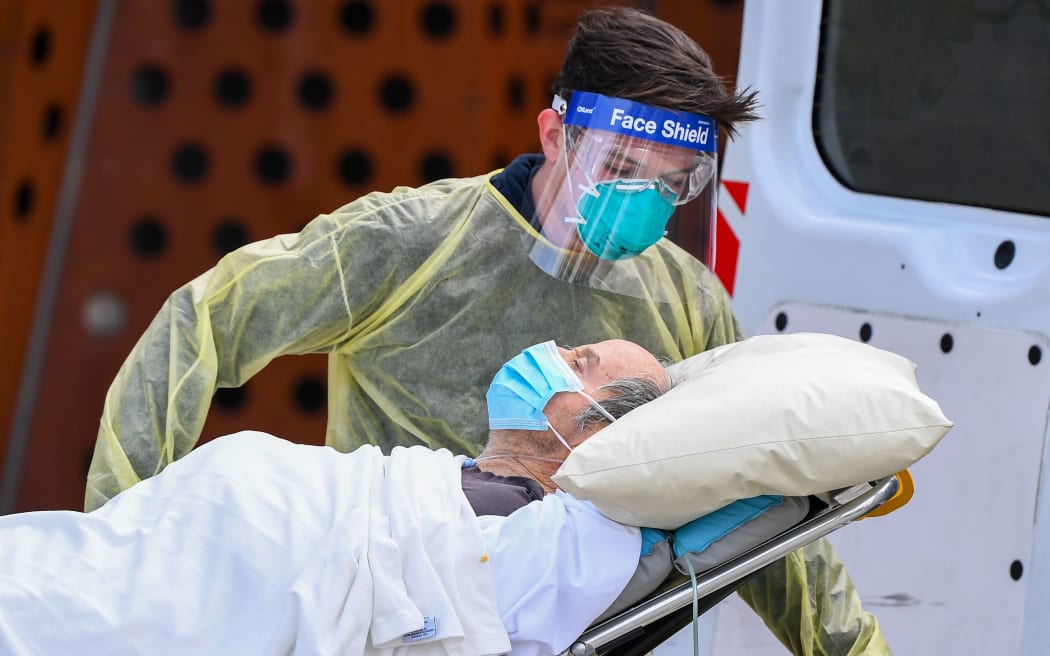 Ambulance officers transfer a resident from the Epping  Gardens aged care facility in the Melbourne suburb of Epping on July 28, 2020 as the city battles fresh outbreaks of the COVID-19 coronavirus.
