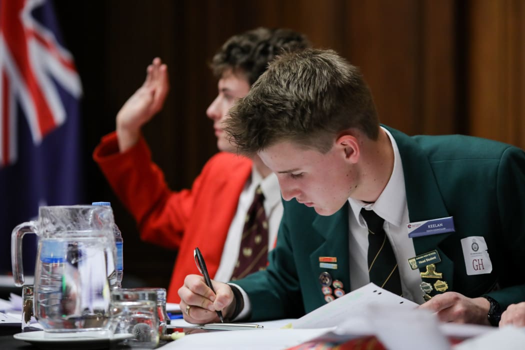 Edward Brougham raises a point with the current speaker, while Keelan Heesterman preps.