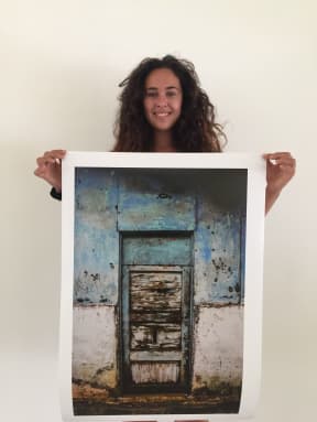 Fe'ena Syme-Buchanan with one of her photographs on display at the "Secluded Splendour" exhibition in Rarotonga