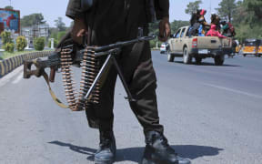 A Taliban fighter stands guard on a street in Herat on August 14, 2021.