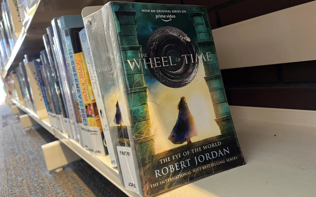 The Wheel of Time book, The Eye of the World, by Robert Jordan on the library bookshelf