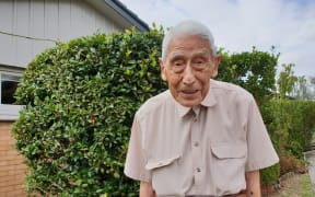 John Sato in his garden at home