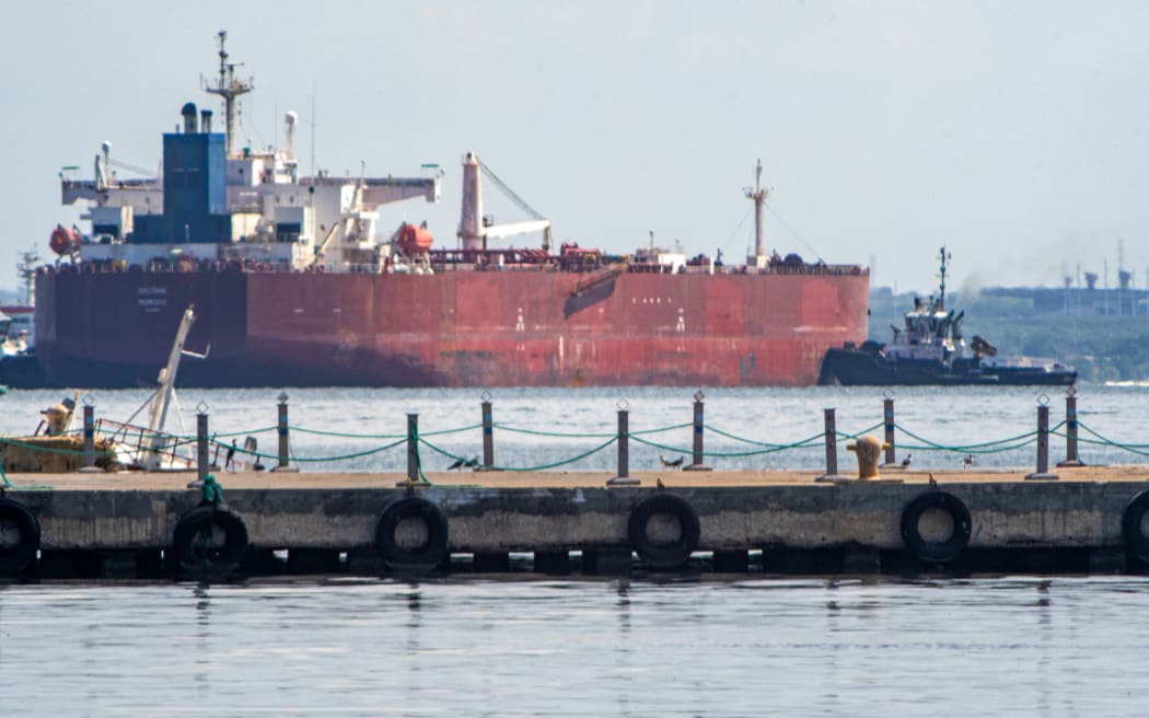 A crude oil tanker is anchored on Lake Maracaibo near Maracaibo, Zulia state, Venezuela, on December 18, 2025. Venezuela struck a defiant note on December 17, insisting that its crude oil exports were not impacted by US President Donald Trump's announcement of a potentially crippling blockade. (Photo by Alejandro Paredes / AFP)