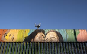 Paintings on the US-Mexico border at the Friendship Park seen from Baja California state in Mexico on January 16, 2021.