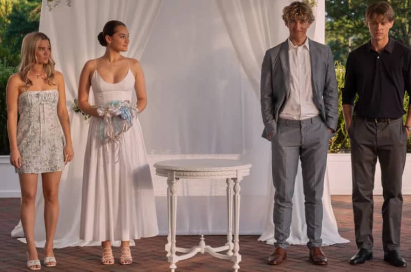 Four young people stand at an altar in formal clothing.
