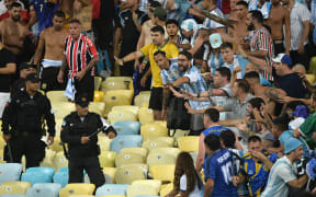 Brazilian police clash with fans of Argentina before the start of the World Cup qualification match at Maracana Stadium in Rio de Janeiro.