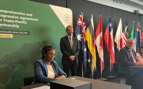 UK Secretary of State for Business and Trade Kemi Badenoch signing the Comprehensive and Progressive Agreement for Trans-Pacific Partnership in Auckland on 16 July 2023 as New Zealand Prime Minister Chris Hipkins looks on.