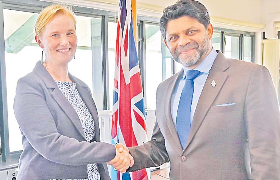 New Zealand High Commissioner to Fiji Charlotte Darlow and Fiji's Attorney-General and Minister for Economy Aiyaz Sayed-Khaiyum seal the deal with a handshake.