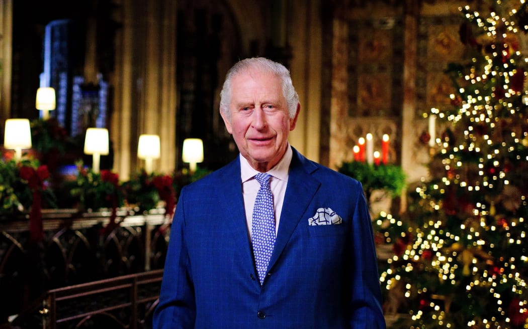 A picture released on December 23, 2022 shows Britain's King Charles III posing for a photograph during the recording his first annual Christmas Day message, in the Quire of St George's Chapel at Windsor Castle, west of London on December 13, 2022. (Photo by Victoria Jones / POOL / AFP) / EMBARGOED: Not for publication in any territory before 2200 GMT TIME.