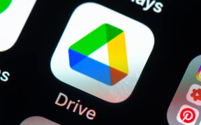 Google Drive app icon on Apple iPhone screen. Google Drive is a file storage and synchronization service.