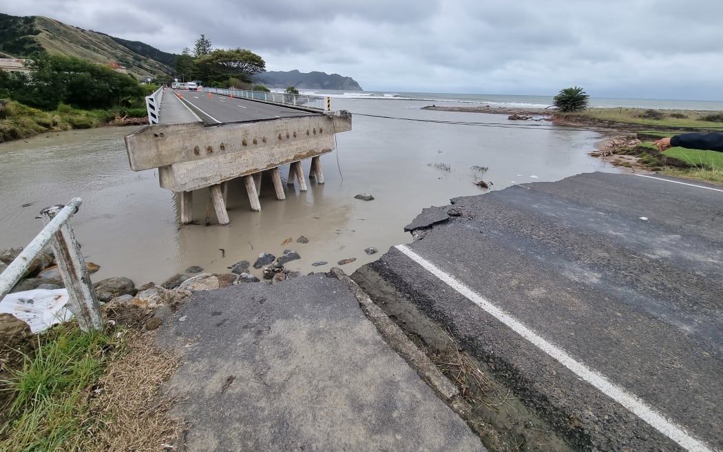 A bridge on the main highway has been ripped in half, tearing the town of Tokomaru Bay in two, with no way to get across instead of swimming, using a horse or getting special vehicles.