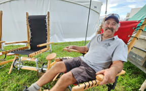Vaughan "Woodzy" Wood in one of the rockers he designed using tynes, a farming implement, to give the rocking motion