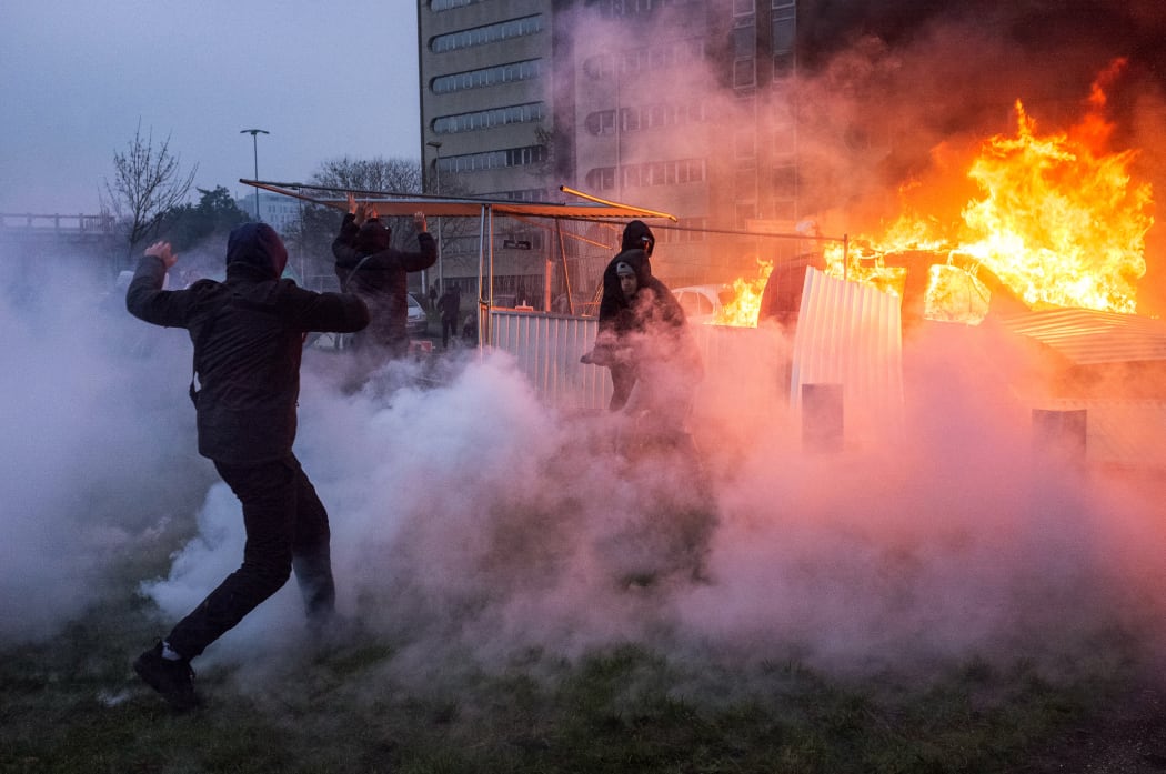 A car is ablaze in the Paris suburb of Bobigny during a protest against police brutality sparked by the arrest of a young man called Theo.