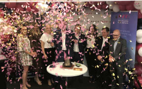 Auckland Real Estate Trust independent director, Nick Hargreaves rings the bell to commemorate the start of trading
