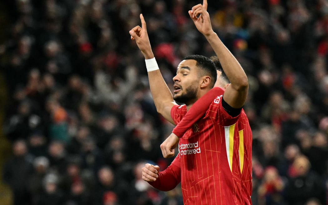 Liverpool's Dutch striker #18 Cody Gakpo celebrates scoring the team's second goal during the UEFA Champions League football match between Liverpool and Real Madrid at Anfield in Liverpool, north west England on November 27, 2024.