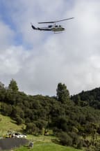 An excavator is helicoptered into a remote area of the SH3 Te Ara o Te Ata: Mt Messenger Bypass project site.
