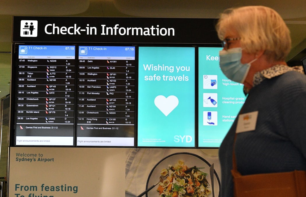 A woman proceeds to the check-in counter for New Zealand flights at Sydney International Airport on April 19, 2021, as Australia and New Zealand opened a trans-Tasman quarantine-free travel bubble.
