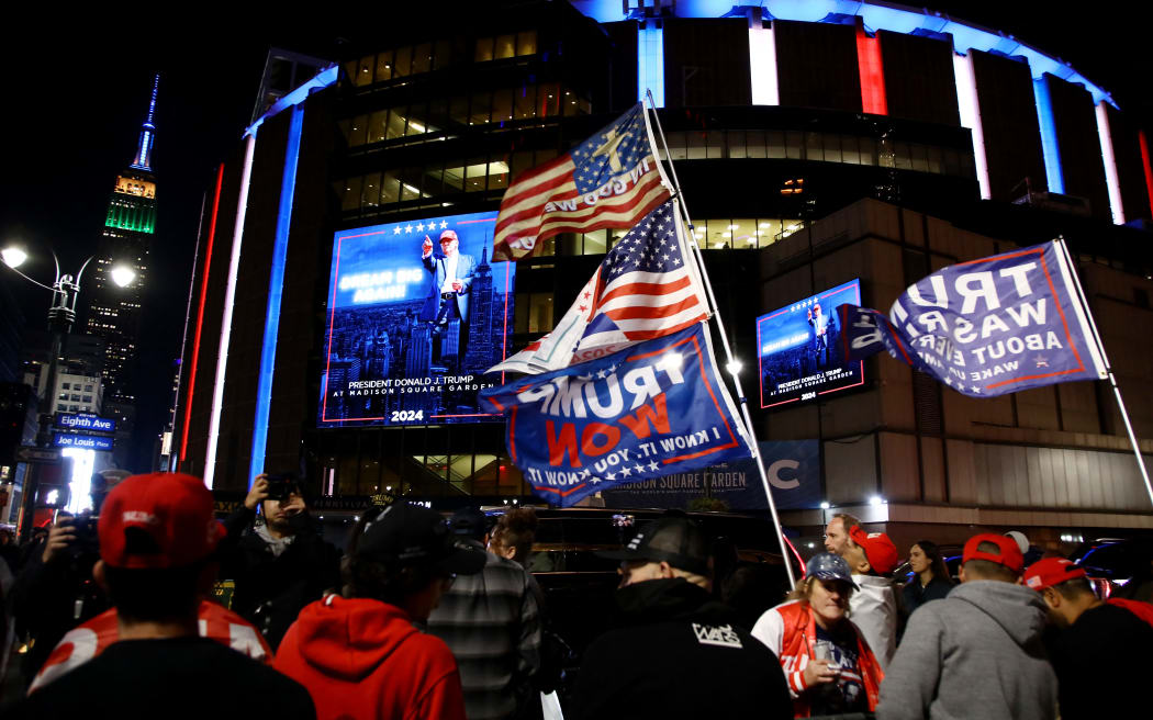 Donald Trump supporters wait outside Madison Square Garden where former US President and Republican presidential candidate Donald Trump holds a campaign rally in New York, October 27, 2024. (Photo by Leonardo Munoz / AFP)
