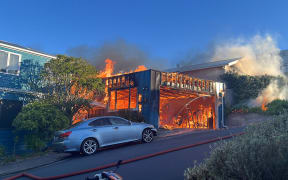 Firefighters at the scene of a house fire in Island Bay, Wellington, 3 November 2025.