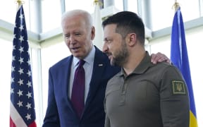 US President Joe Biden (L) walks with Ukraine's President Volodymyr Zelensky ahead of a working session on Ukraine during the G7 Leaders' Summit in Hiroshima on May 21, 2023. (Photo by Susan Walsh / POOL / AFP)