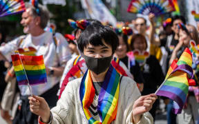 A participant attends the Tokyo Rainbow Pride 2023 Parade in Tokyo on April 23, 2023, to show support for members of the LGBT community. (Photo by Yuichi YAMAZAKI / AFP) / IMAGE RESTRICTED TO EDITORIAL USE
