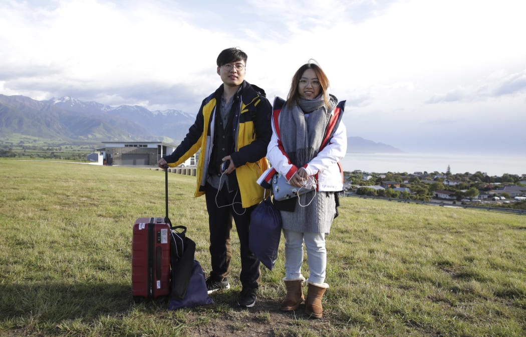 Chinese tourists Xiaolei Chen and Jiangyong are honeymooning in New Zealand. They were evacuated by the Chinese consulate.
