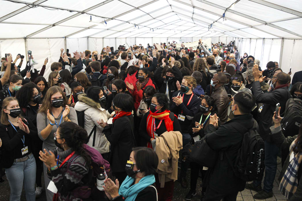 Climate activists and delegates stage a walk out in protest of the ongoing negotiations at the COP26 climate change conference.