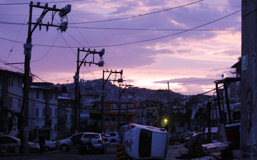 Damaged vehicles piled up in a street in Acapulco, Mexico, during Hurricane Otis, on 28 October, 2023.