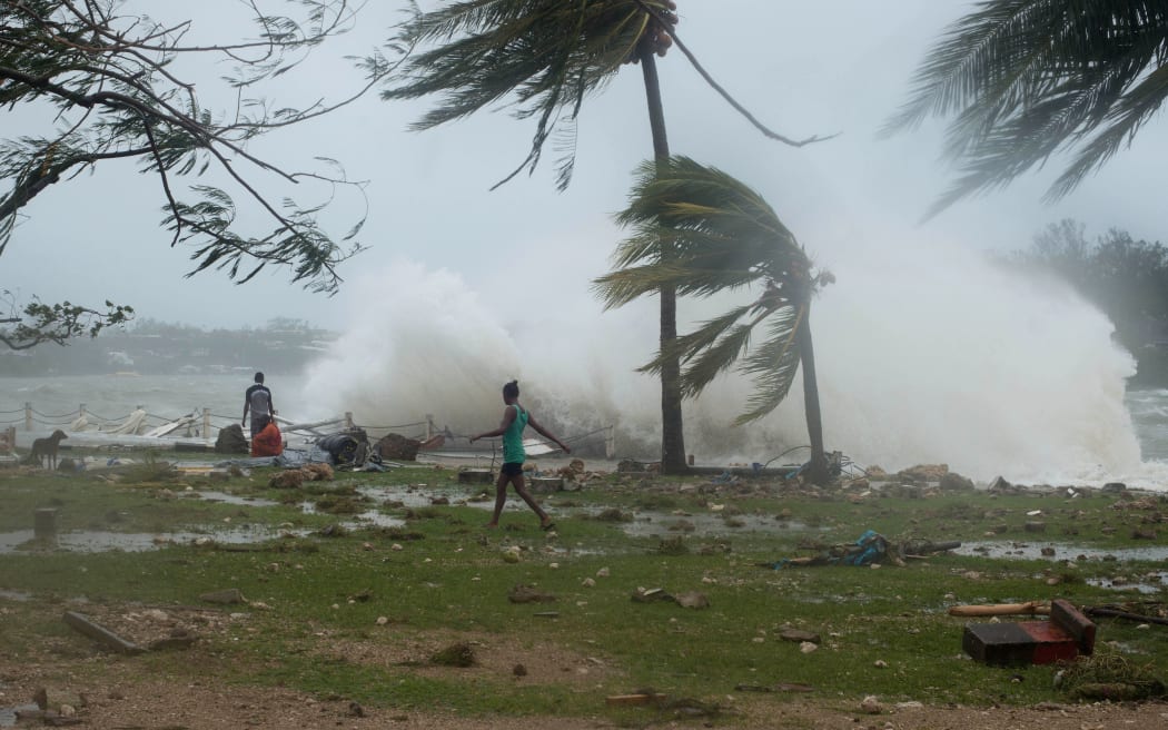 Waves and scattered debris along the coast, caused by Cyclone Pam