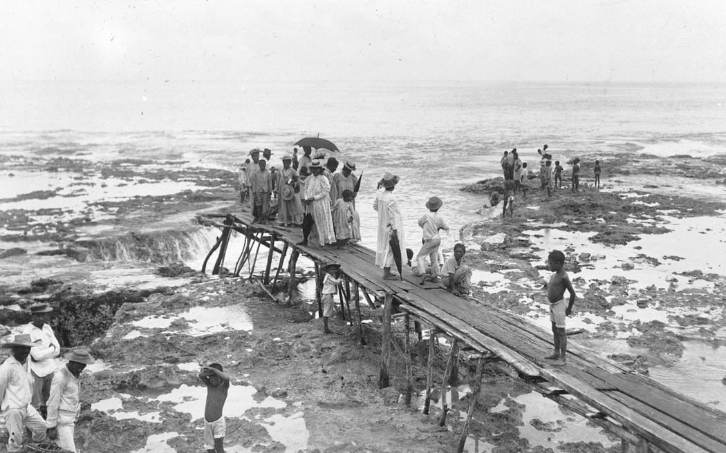 Cover picture on: Niue 1774–1974: 200 years of contact and change. Author Margaret Pointer. People gather on the wharf at Alofi in 1900 as the governor’s party prepares to come ashore.