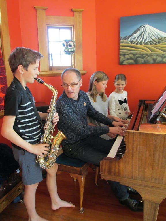 Children learn how to play at the Nelson School of Music