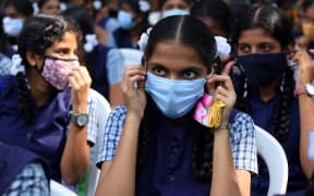 India, Chennai, 2022-01-03. A schoolgirl wears a mask during the vaccination camp at a school in Chennai.