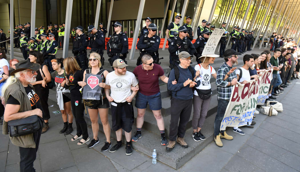 Climate change protesters link arms as they attempt to blockade the International Mining and Resources Conference (IMARC) being held in Melbourne on 29 October, 2019.