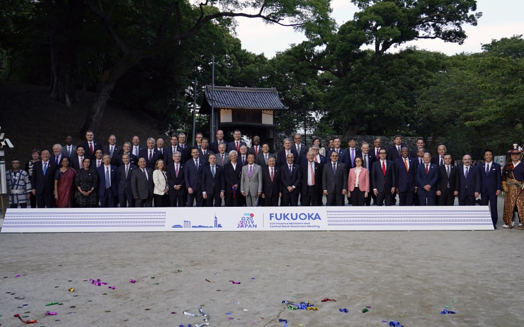 Japan's Finance Minister Taro Aso poses with delegation members during a photo of the G20 finance ministers and central bank governors meeting in Fukuoka.