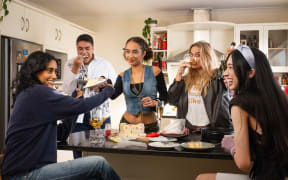 The cast of Takahoa celebrating by eating a cake