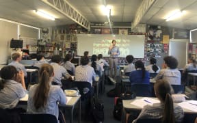 Teacher Jerome Cargill with his Year 13 Media Studies students at Macleans College