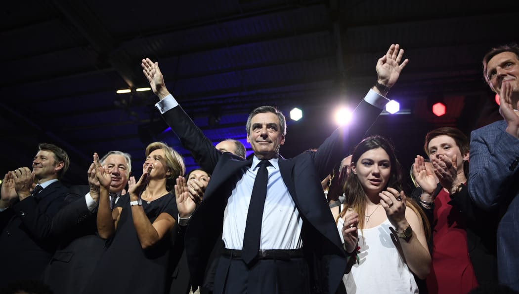French presidential election candidate for the right-wing Les Republicains (LR) party Francois Fillon (C) gestures during a rally at the Porte de Versailles in Paris, on April 9, 2017.