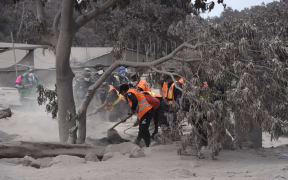 Members of Guatemalan Army and police officers, search for victims in the ash-covered village of San Miguel Los Lotes, in Escuintla department, about 35 km southwest of Guatemala City, two days after the eruption of the Fuego Volcano, on June 5, 2018.