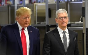 Donald Trump (L) and Apple CEO Tim Cook tour the Flextronics computer manufacturing facility where Apple's Mac Pros are assembled in Austin, Texas, on 20 November, 2019.