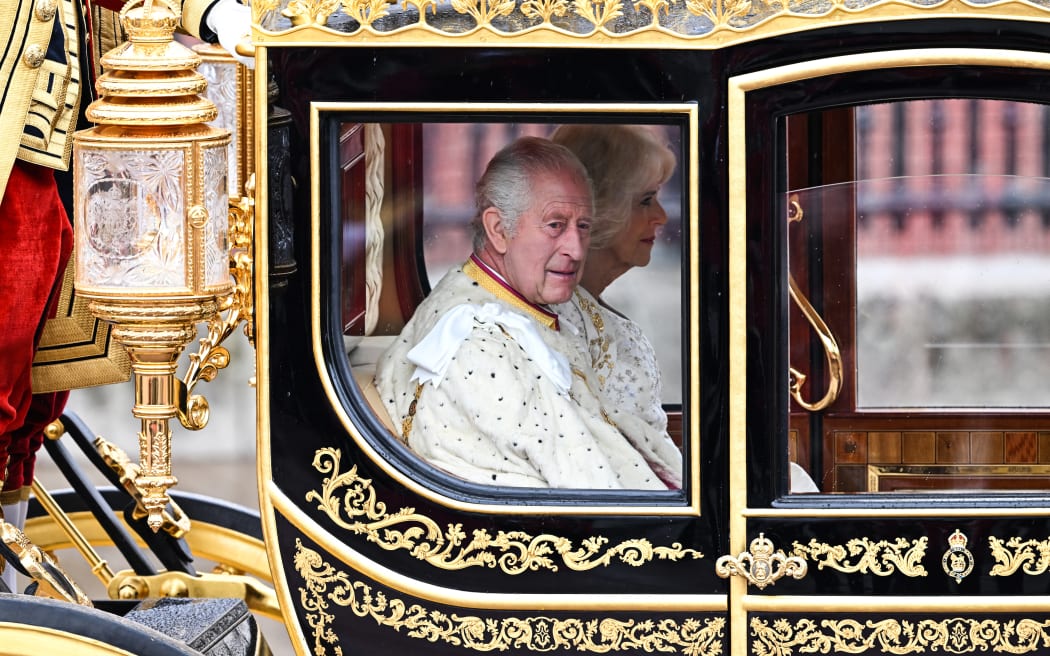 Britain's King Charles III and Britain's Camilla, Queen Consort begin their journey in the Diamond Jubilee State Coach, in the 'King's Procession', a journey of two kilometres from Buckingham Palace to Westminster Abbey in central London on May 6, 2023, ahead of their coronations. - The set-piece coronation is the first in Britain in 70 years, and only the second in history to be televised. Charles will be the 40th reigning monarch to be crowned at the central London church since King William I in 1066. Outside the UK, he is also king of 14 other Commonwealth countries, including Australia, Canada and New Zealand. Camilla, his second wife, will be crowned queen alongside him and be known as Queen Camilla after the ceremony. (Photo by Oli SCARFF / AFP)