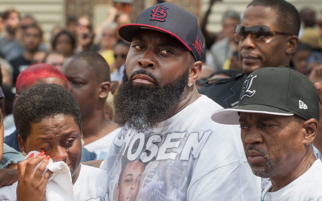 Michael Brown Sr. comforts his wife Cal Brown during a moment of silence in Ferguson