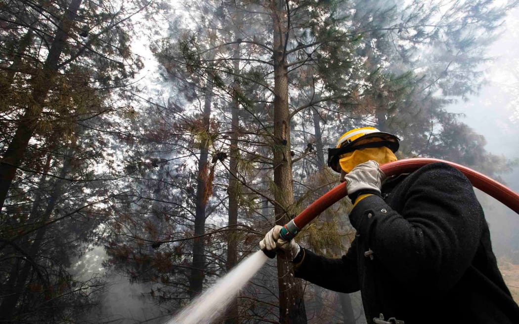 A firefighter hard at work in the Port Hills, Christchurch. Photo taken 18 February 2017.