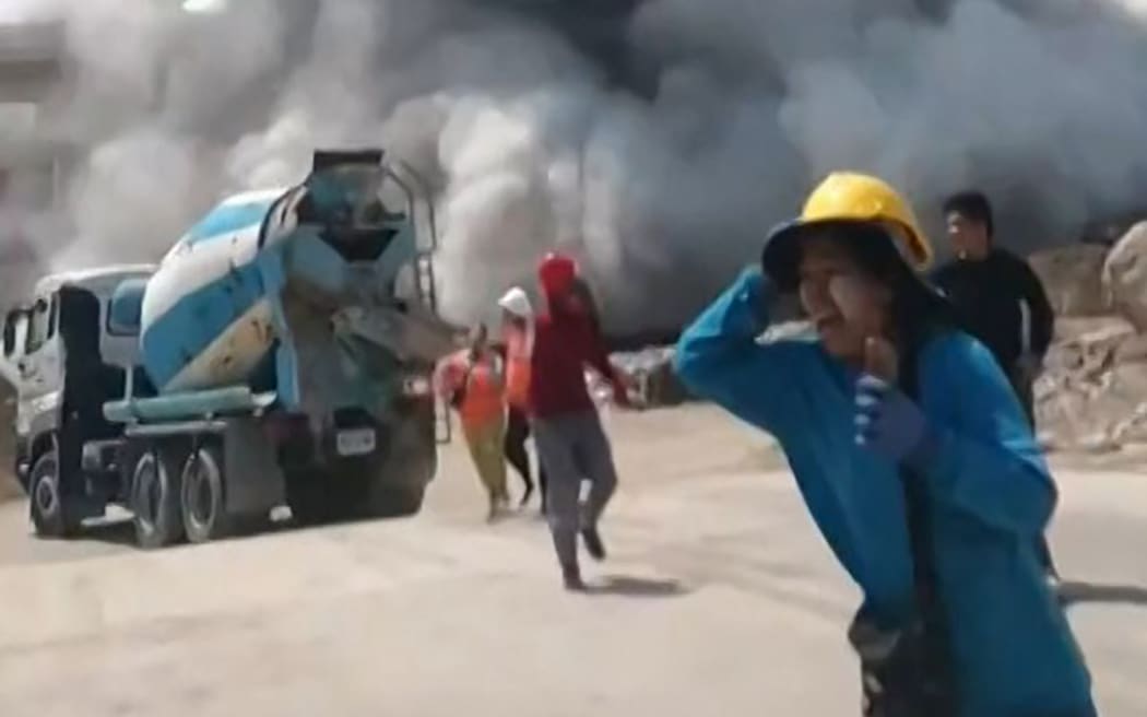 This frame grab from UGC video footage taken and posted by Khon Su Cheevit Adeet Mai Suay Rok Na on Facebook on March 28, 2025 shows workers running away from a building as it collapses at a construction site in Bangkok, following an earthquake. A powerful earthquake rocked central Myanmar on March 28, buckling roads in capital Naypyidaw, damaging buildings and forcing people to flee into the streets in neighbouring Thailand. (Photo by Handout / Courtesy of Facebook user Khon Su Cheevit Adeet Mai Suay Rok Na / AFP) / NO USE AFTER APRIL 11, 2025 12:29:17 GMT - NO USE AFTER APRIL 11, 2025 12:29:17 GMT - -----EDITORS NOTE --- RESTRICTED TO EDITORIAL USE - MANDATORY CREDIT "AFP PHOTO / COURTESY OF FACEBOOK USER KHON SU CHEEVIT ADEET MAI SUAY ROK NA " - NO MARKETING - NO ADVERTISING CAMPAIGNS - DISTRIBUTED AS A SERVICE TO CLIENTS  - NO ARCHIVES /