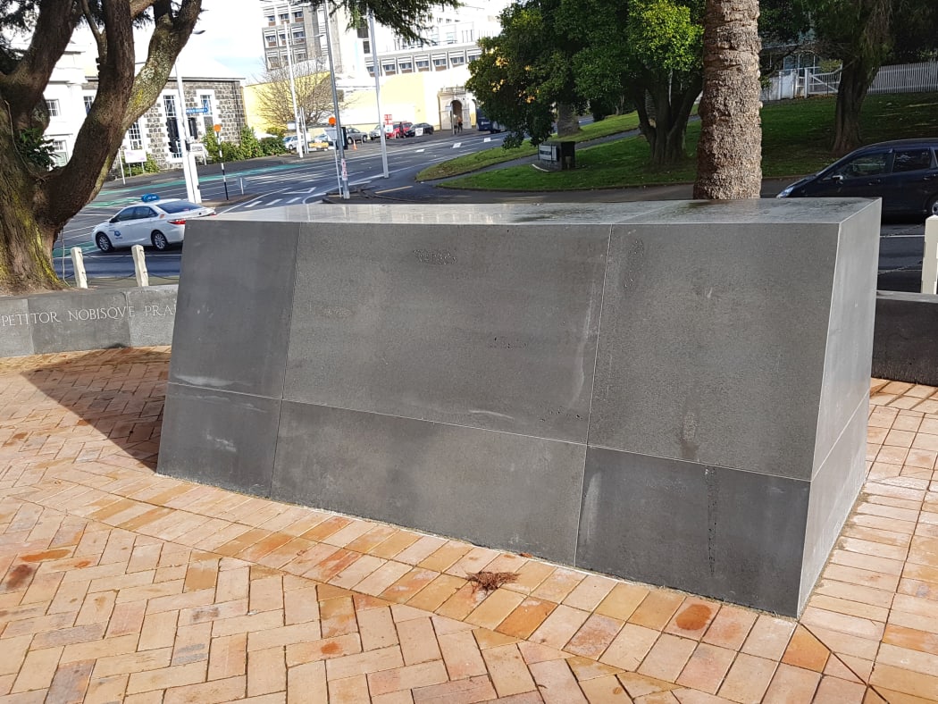 The judge's name has been removed from the large marble plinth.