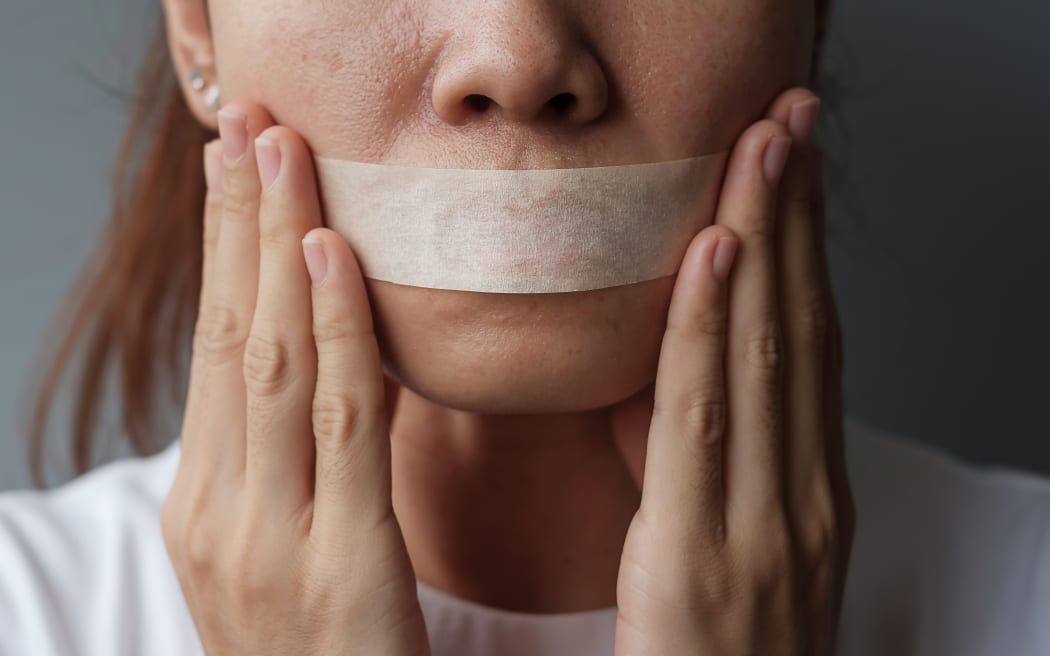 woman with mouth sealed in adhesive tape. Free of speech, freedom of press, Human rights, Protest dictatorship, democracy, liberty, equality and fraternity concepts