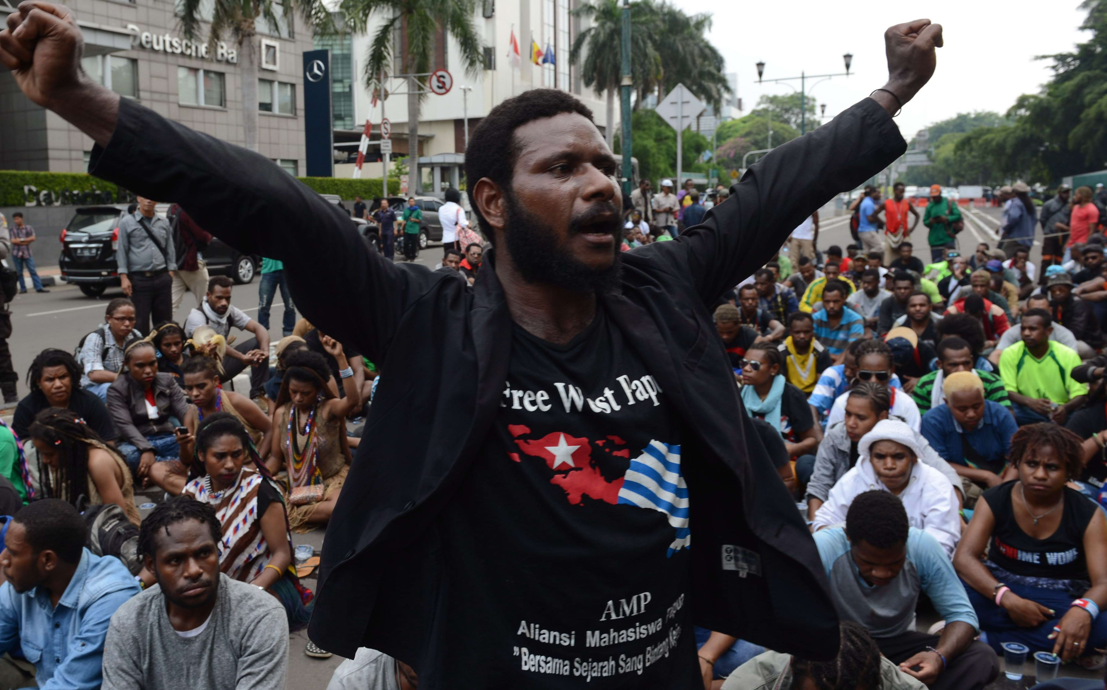 Papuan pro-independence demonstrators stage a protest in Jakarta on December 1, 2015, before police fired tear gas at a hundreds-strong crowd hurling rocks during a protest against Indonesian rule over the eastern region of Papua.