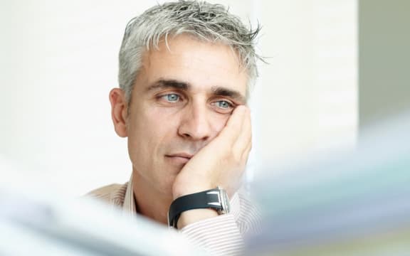Exhausted man with paperwork (Photo by Frank and Helena / Cultura Creative / Cultura Creative via AFP)