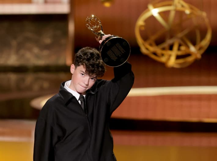LOS ANGELES, CALIFORNIA - SEPTEMBER 14: Owen Cooper accepts the Outstanding Supporting Actor in a Limited or Anthology Series or Movie award for "Adolescence" onstage during the 77th Primetime Emmy Awards at Peacock Theater on September 14, 2025 in Los Angeles, California.   Kevin Winter/Getty Images/AFP (Photo by KEVIN WINTER / GETTY IMAGES NORTH AMERICA / Getty Images via AFP)