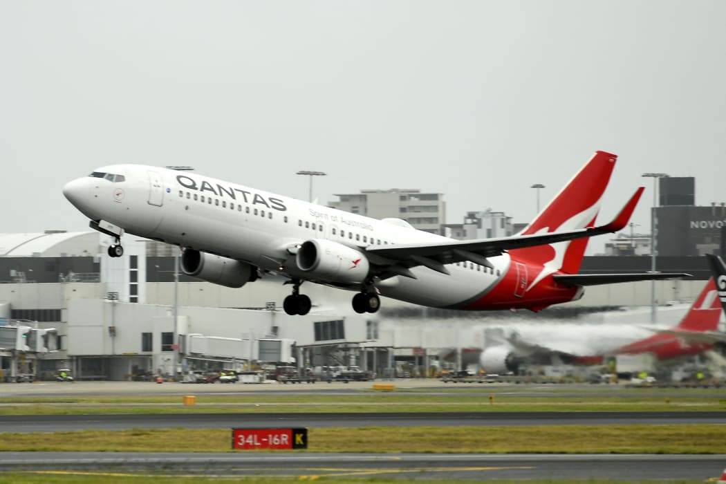 A Qantas plane takes off from the Sydney International airport on May 6, 2021, as Australia's competition regulator said it would block a pricing, code-sharing and scheduling deal between Qantas and Japan Airlines because it would likely mean higher fares for passengers. (Photo by Saeed KHAN / AFP)